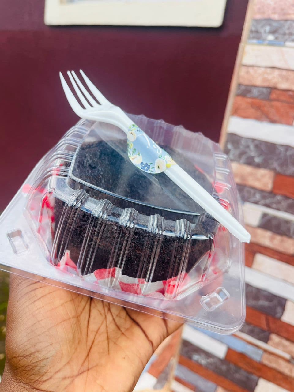 Slice of chocolate cake in a takeaway box