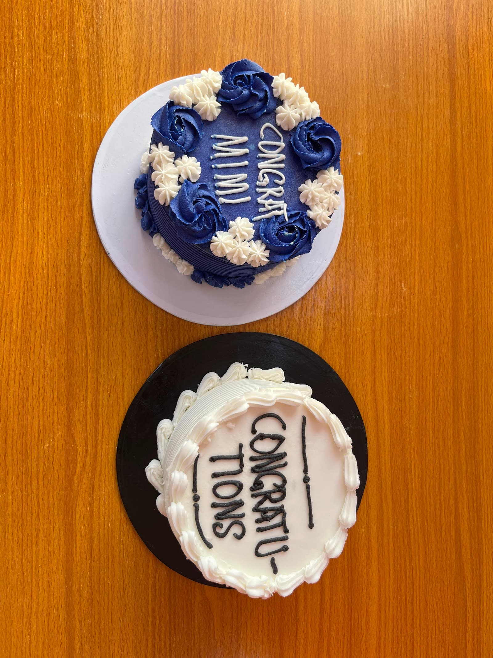 Two congratulations cakes seen from above
