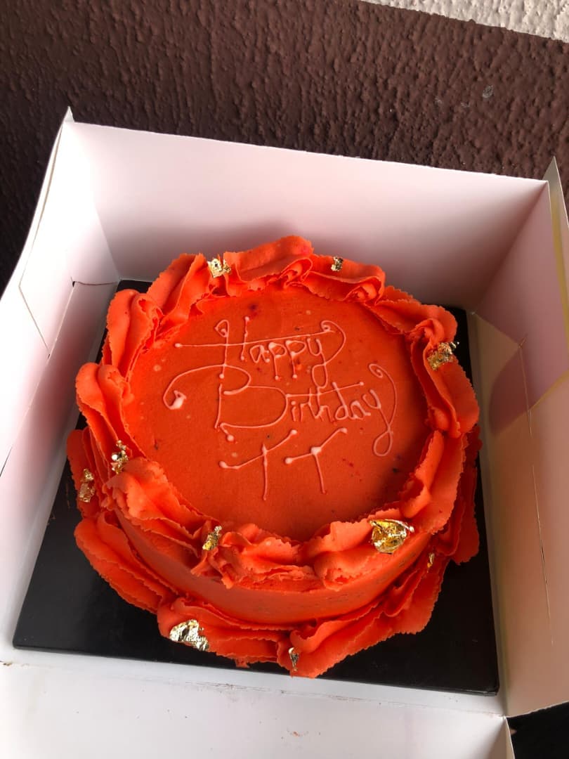 Orange birthday cake in its box