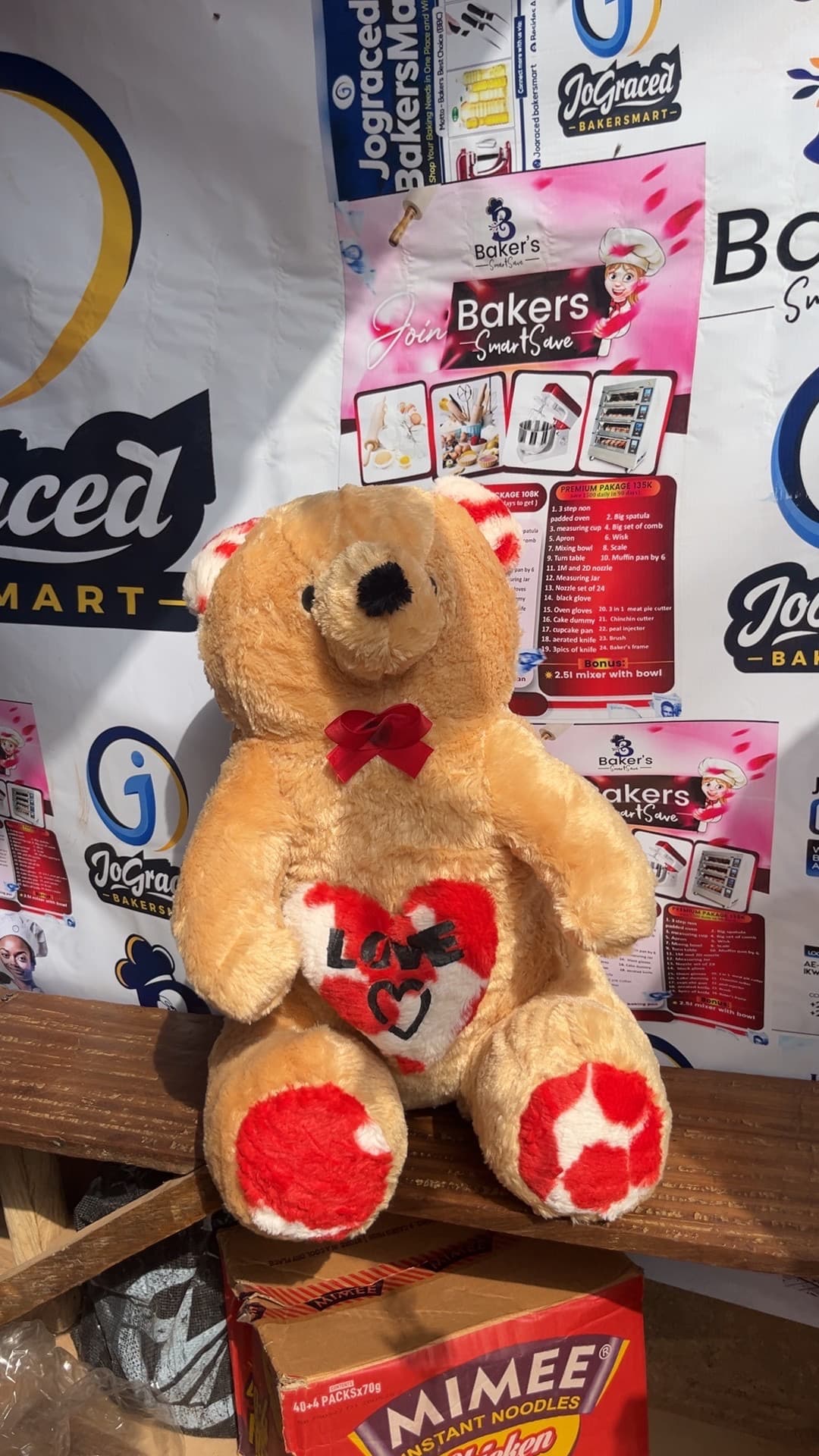 Brown teddy bear holding a heart